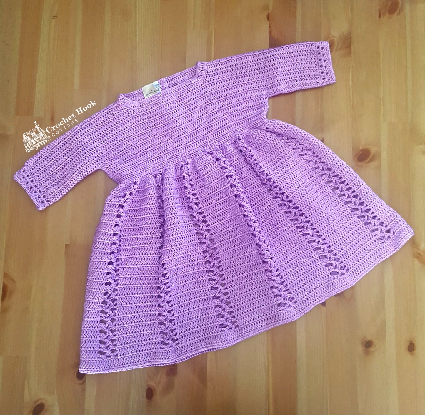 Front view of the Lilac Sally Toddlers Dress fits ages 12-18 months, crocheted dress three quarter length sleeves with lace panel features on dress - www.crochethookcottage.com