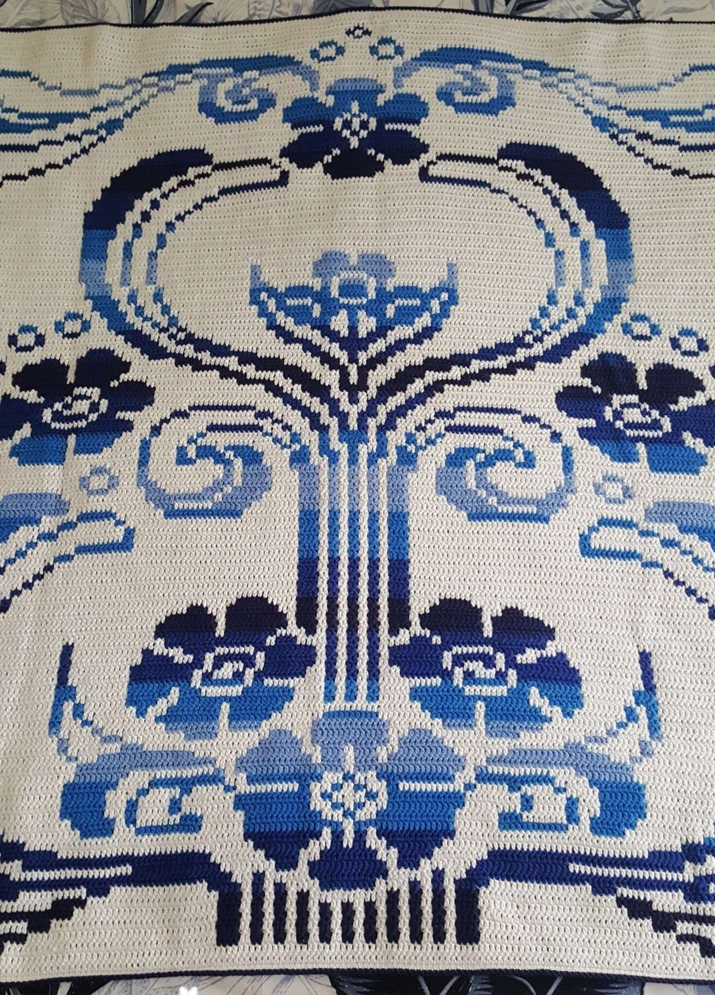 Section of the Art Nouveau Blanket showing a stylized pedestal featuring flowers and flourishes in ombre blue on a white background