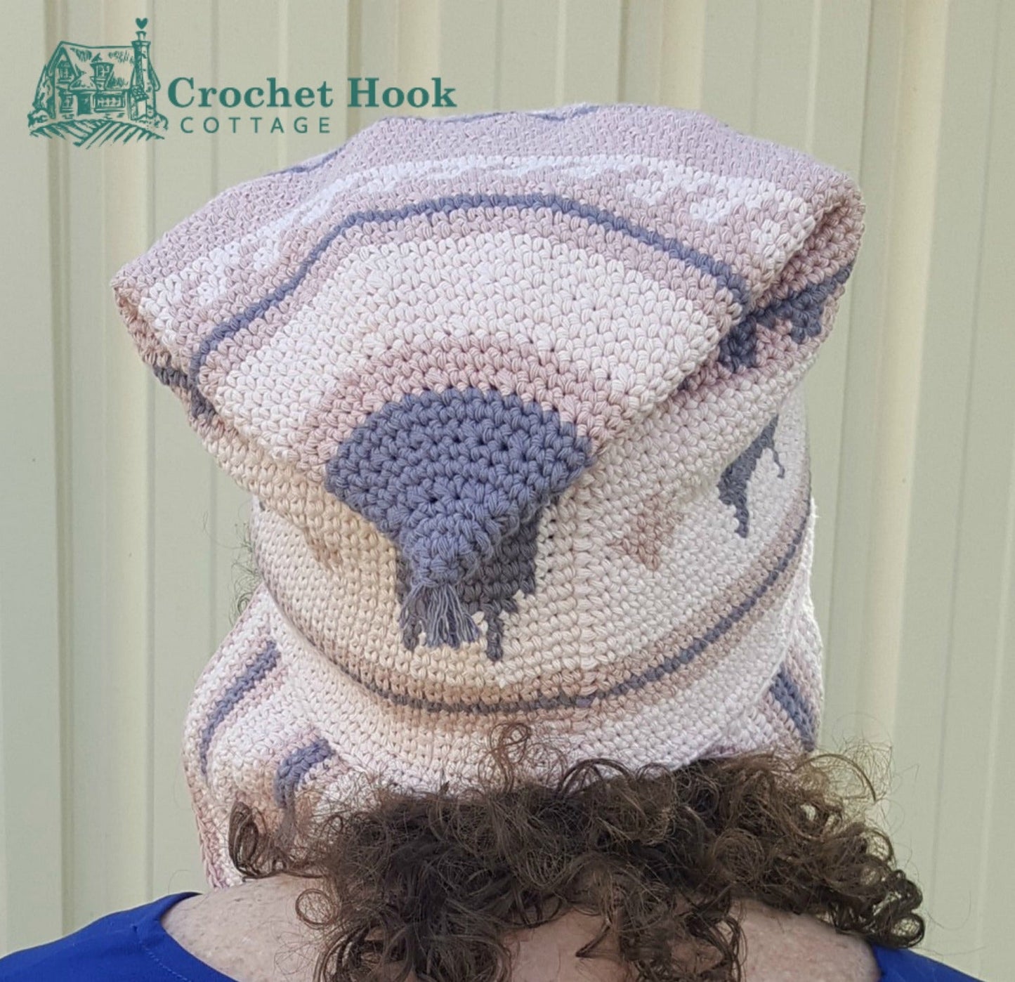 back view of a person wearing the Pink Peruvian Llama Chullo with the peak folded down - www.crochethookcottage.com