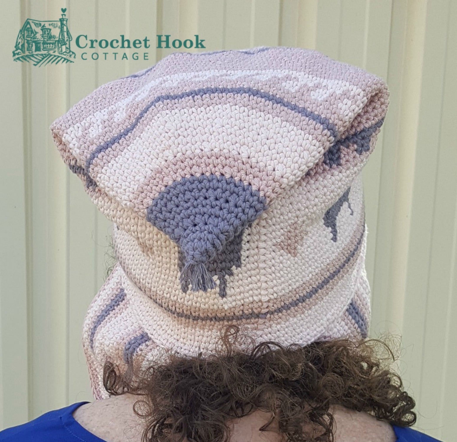 back view of a person wearing the Pink Peruvian Llama Chullo with the peak folded down - www.crochethookcottage.com