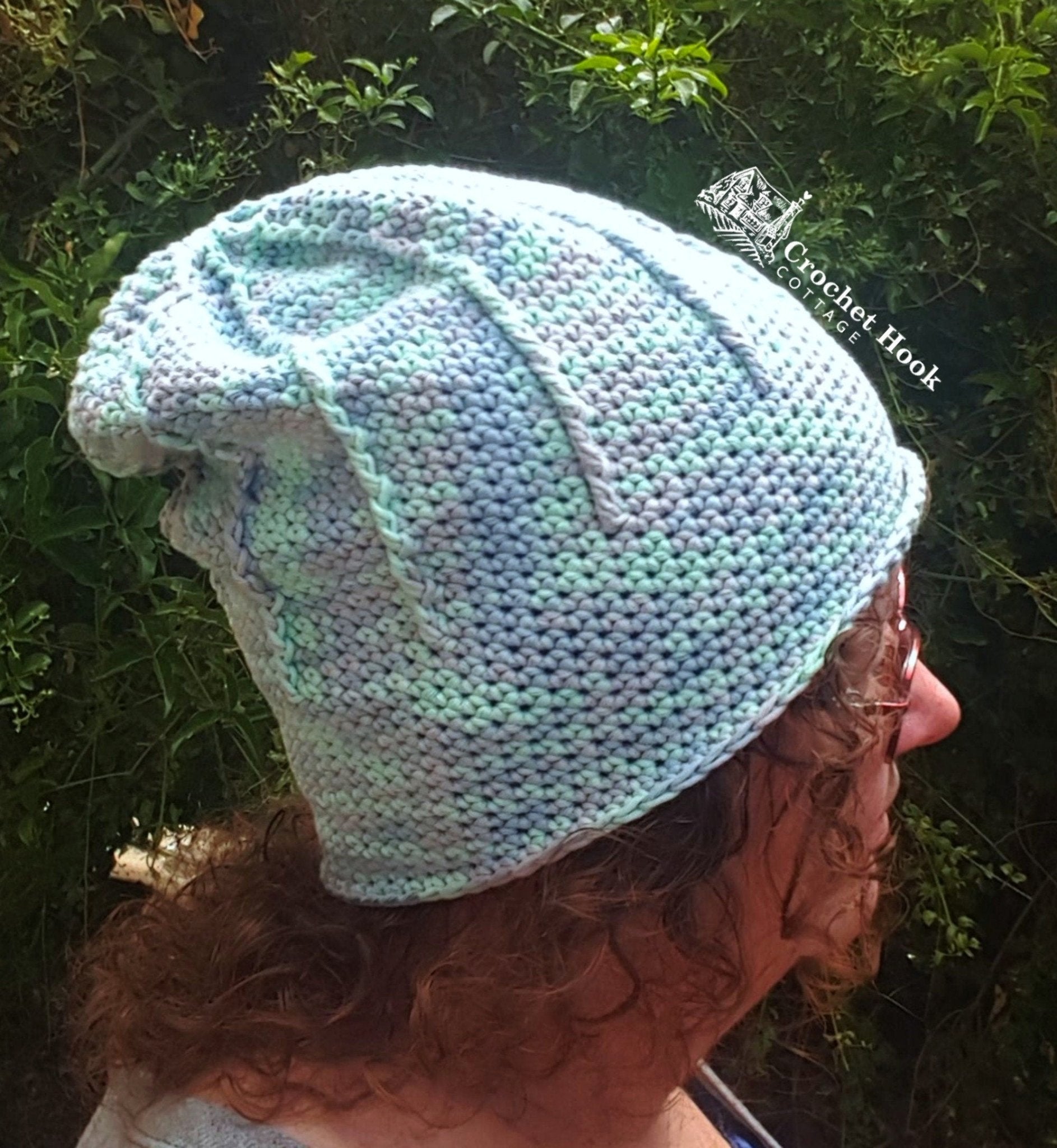 side view of a person wearing the Rolled Brim Slouchy Beanie, 2 styles in 1 convertible beanie in the Alexandra colour, worn slouchy style - www.crochethookcottage.com