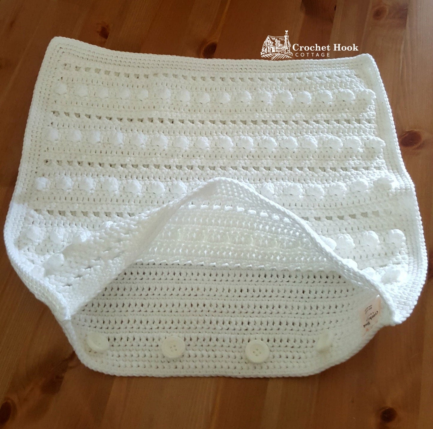 White Cushion Cover "String of Pearls", partially open to show buttons - www.crochethookcottage.com